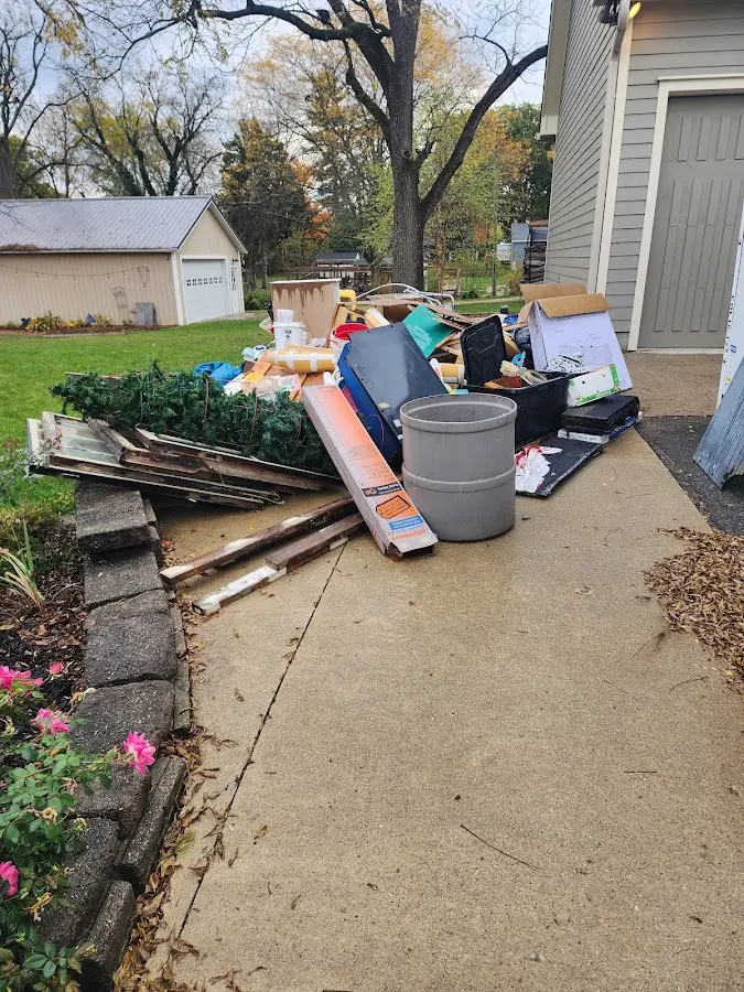 Dumpster being loaded with debris for Residential Dumpster Rental in Coral Gables